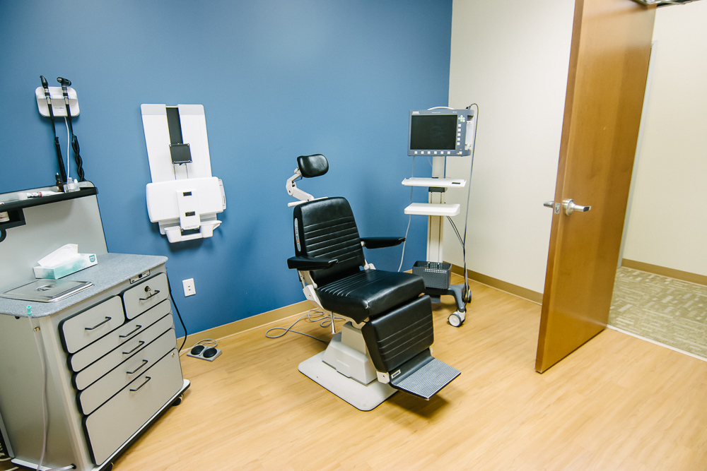 ENT exam room with patient chair and monitor at Peak ENT and Voice Center in Brighton, CO